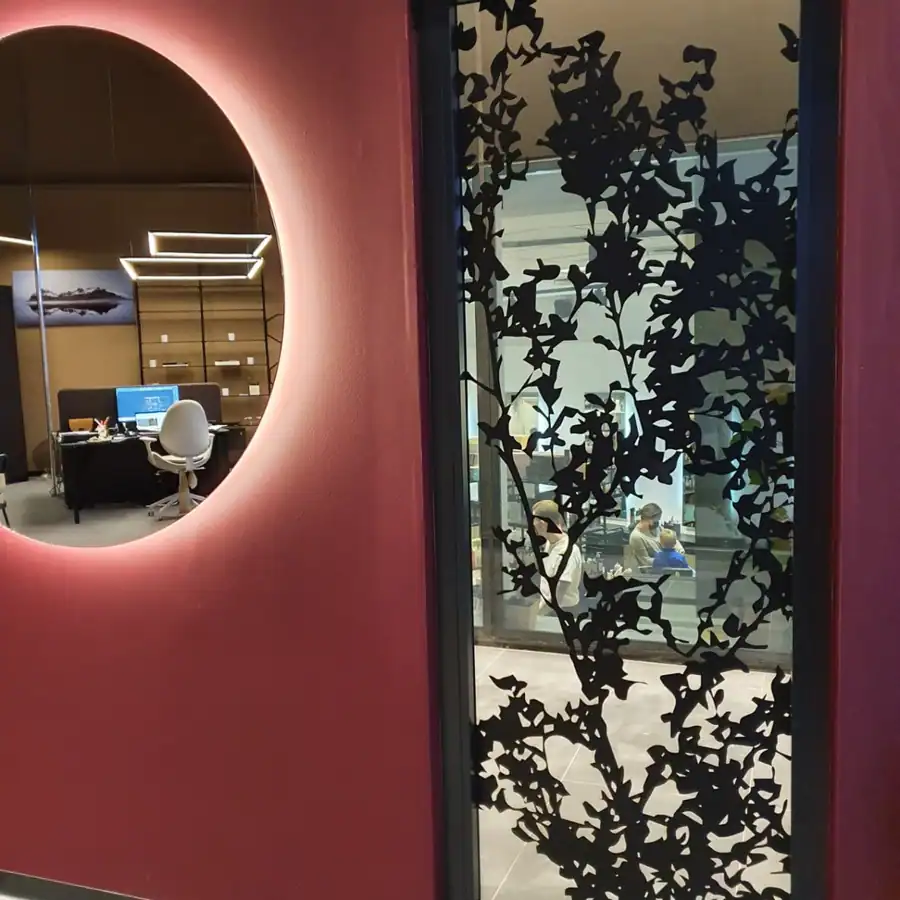 Stofa með steinvegg, bláum chesterfield-sófa, rauðum Egg-stól og sebrateppi